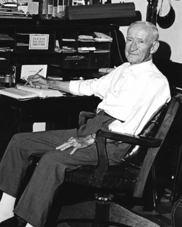 Thomas Y Northern sitting as an old man at a desk.